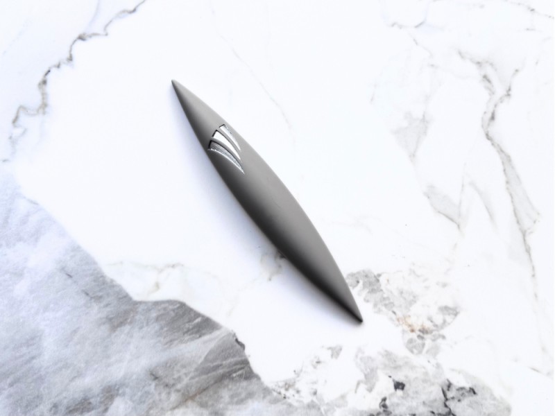 Large grey rocket-shaped stone mezuzah on marble surface