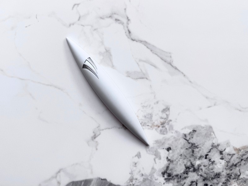 Large white rocket-shaped stone mezuzah on marble surface