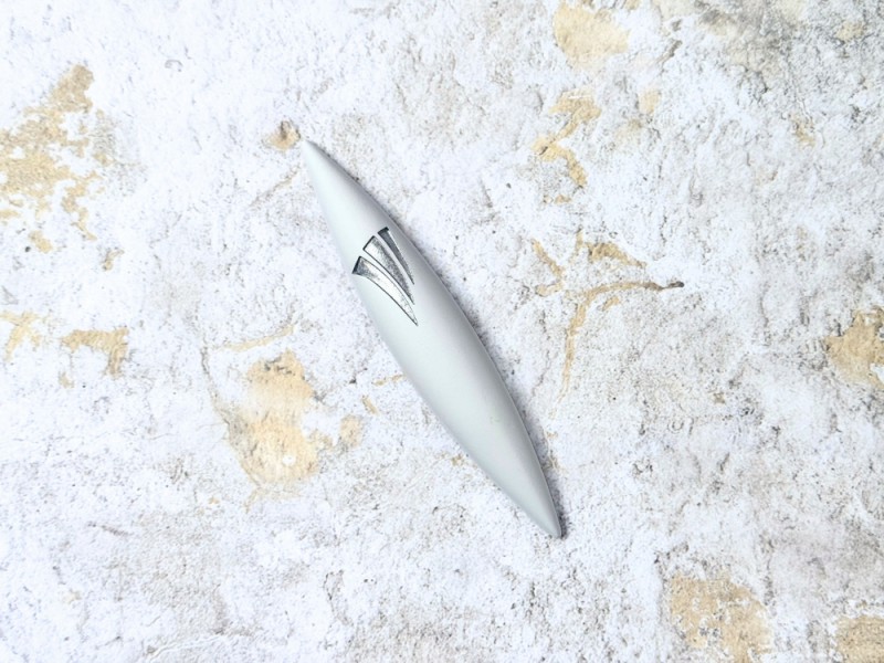 Side view of white rocket-shaped stone mezuzah with silver shin